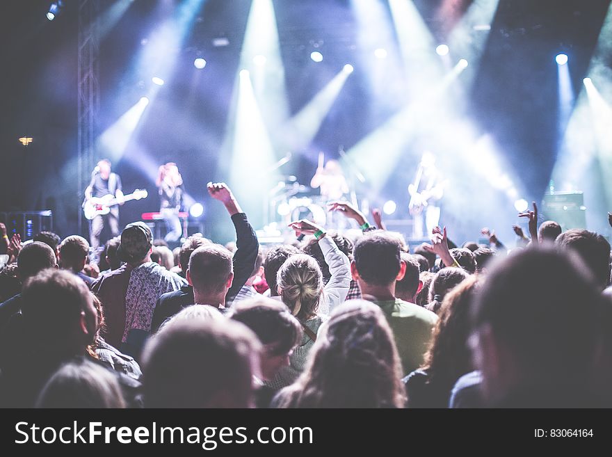 Crowd In Front Of People Playing Musical Instrument During Nighttime