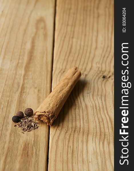 Cinnamon, peppers and seeds on a wooden background. Cinnamon, peppers and seeds on a wooden background.