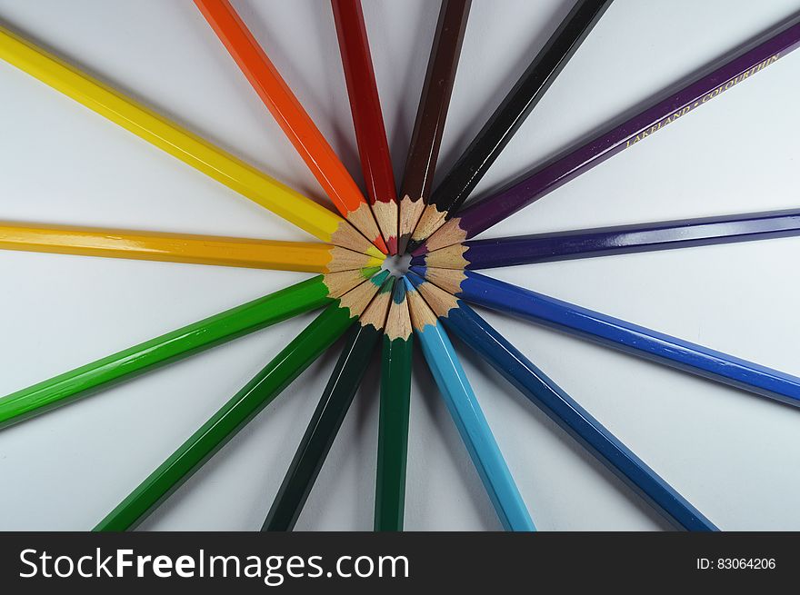 Colorful pencils set in formation with the tips pointing at each other.