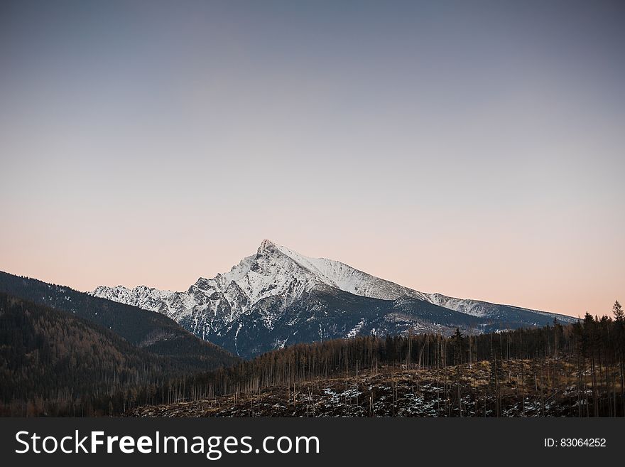 Mountain Glacier Under Cloudy Sky during Daytime