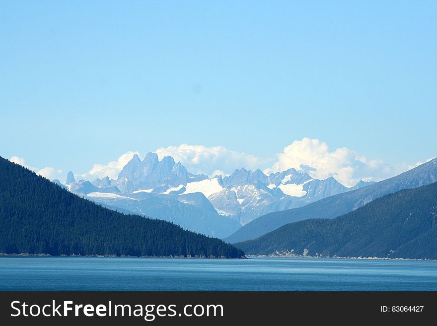 Mountain With Snow Cap Under Cloudy Sky at Daytime