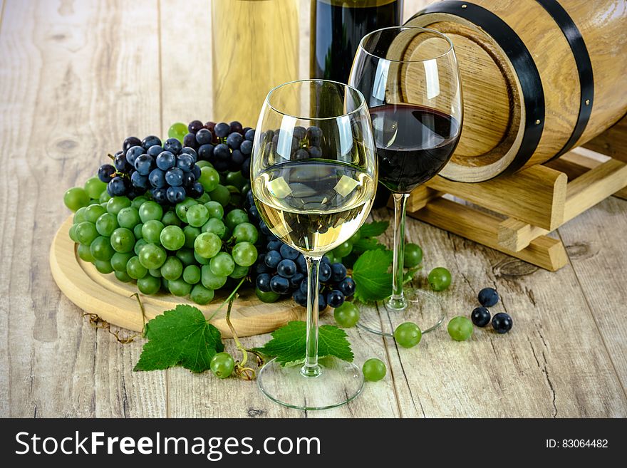 Clear Wine Glass Near Green Grapes
