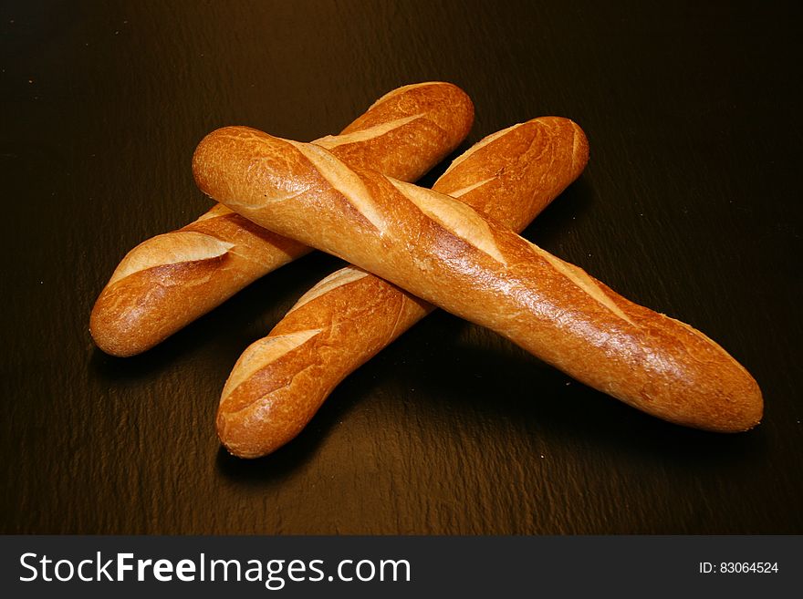 Loaves of crusty french baguettes on wooden table. Loaves of crusty french baguettes on wooden table.