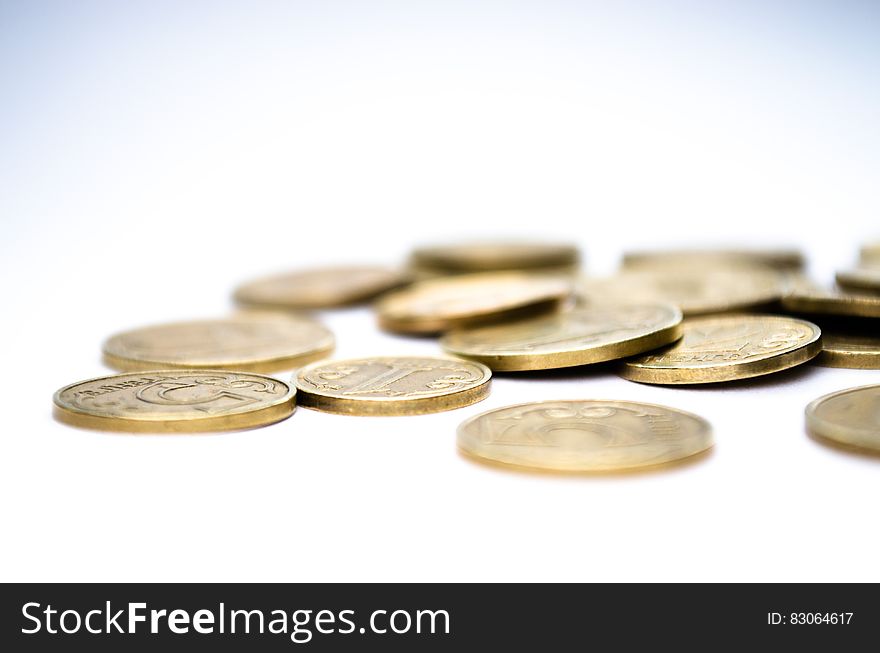 A pile of coins on white background. A pile of coins on white background.