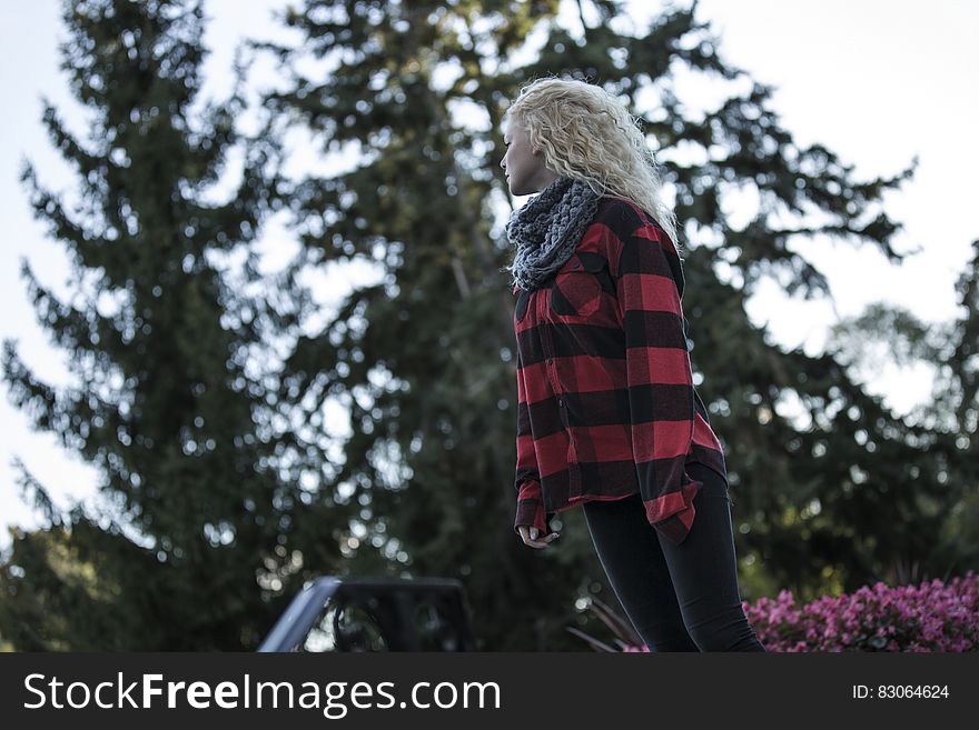 Woman in Black and Red Stripes Long Sleeve Shirt Standing during Daytime