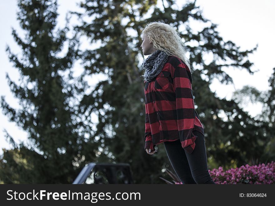 Woman In Black And Red Stripes Long Sleeve Shirt Standing During Daytime