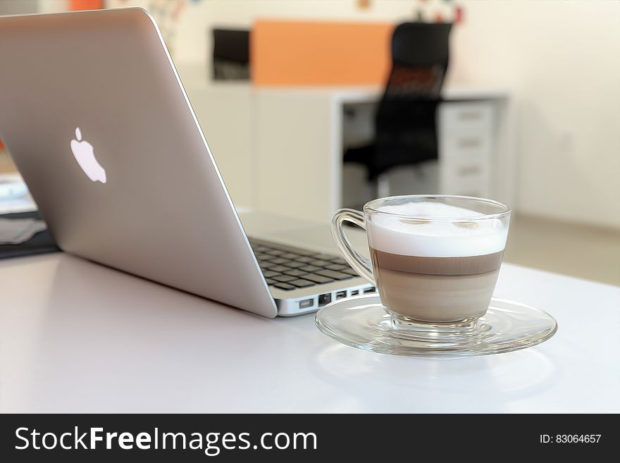 Macbook Pro Besides Clear Glass Mug
