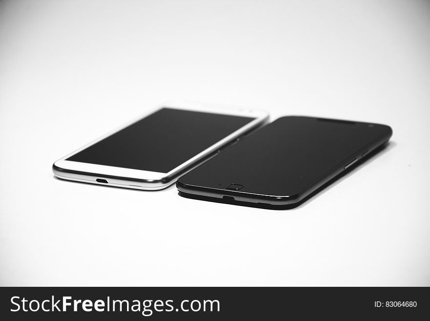 White Android Smartphone Near Black Android Smartphone
