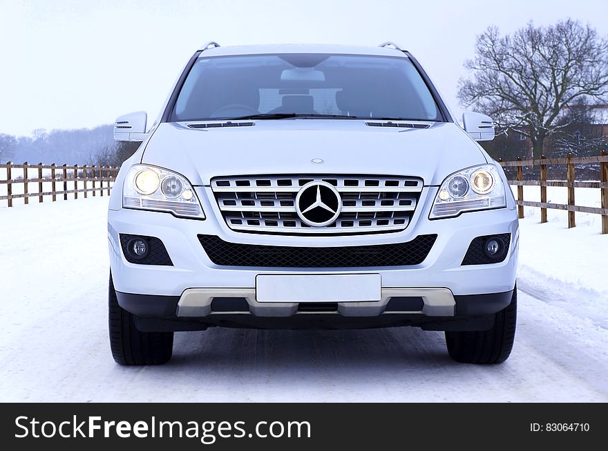 White Mercedes Benz Car on White Snow Covered Ground at Daytime