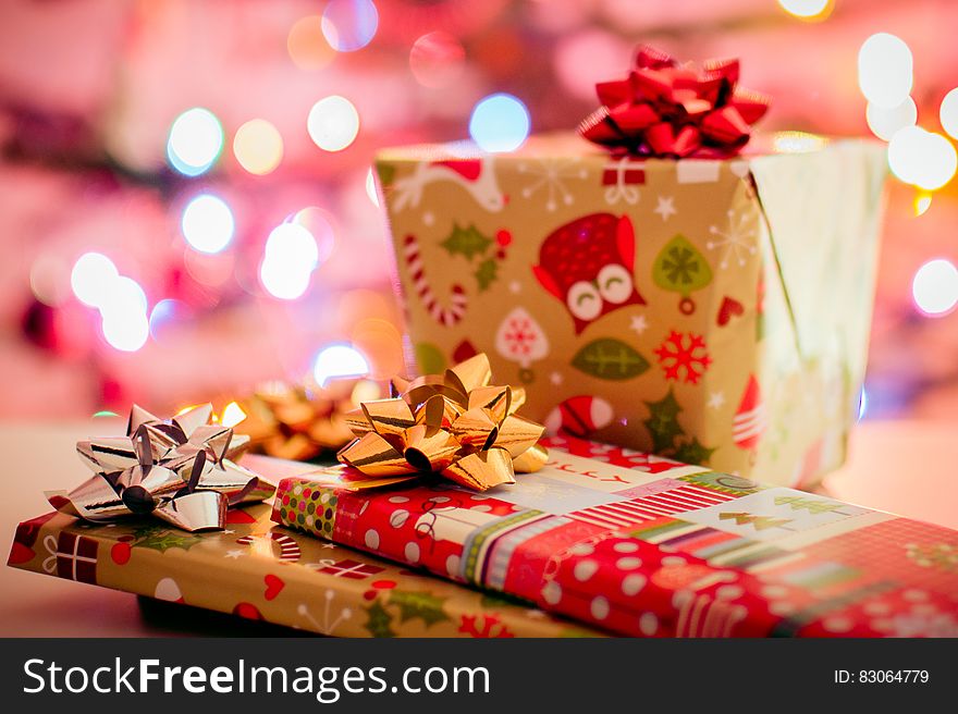 Wrapped Christmas gifts with bokeh light background.