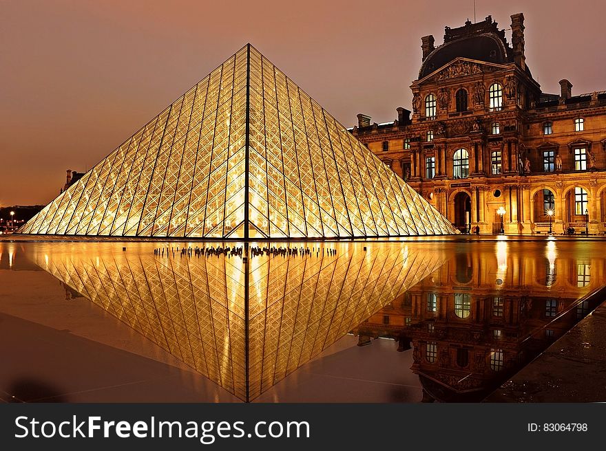 Exterior of glass pyramid at Louvre Museum, Paris, France at night.