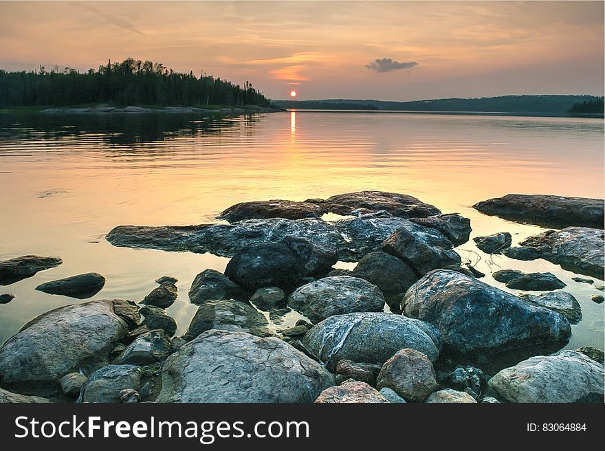 Rocky Lake Shore During Sunset