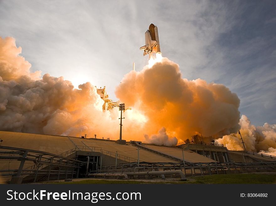 Launch of NASA Space Shuttle in plume of flames and steam. Launch of NASA Space Shuttle in plume of flames and steam.