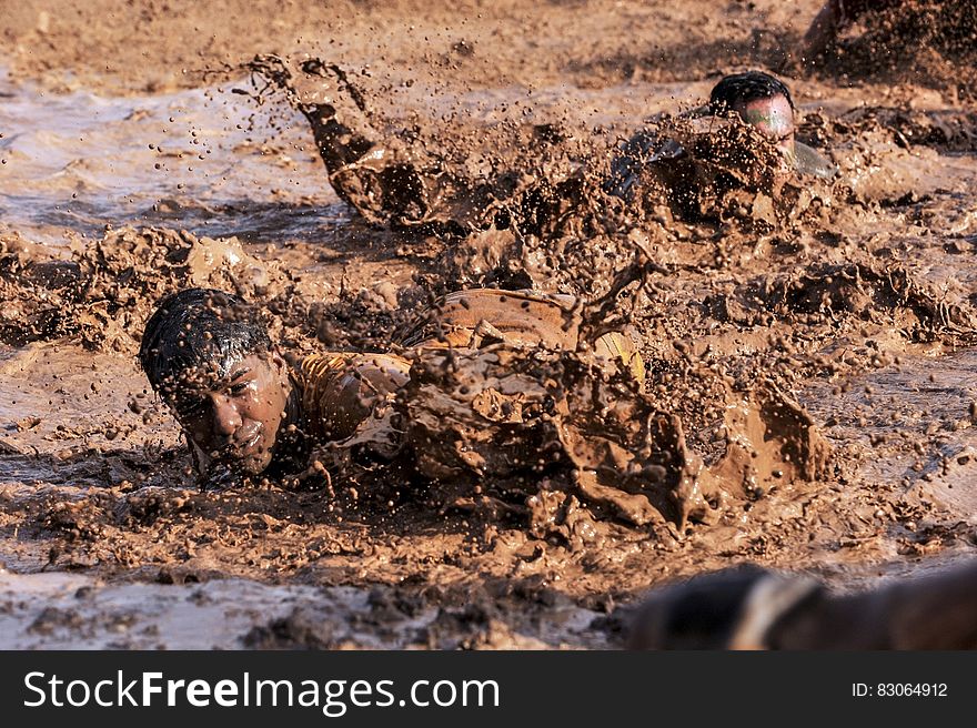 Soldiers in infantry training through mud on sunny day. Soldiers in infantry training through mud on sunny day.