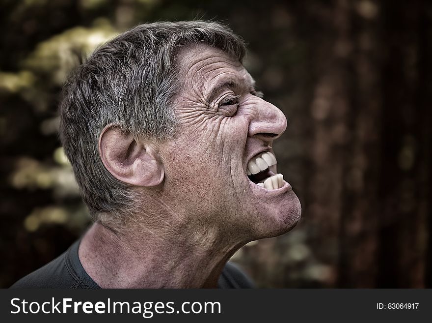 Portrait of man expressing anger outdoors. Portrait of man expressing anger outdoors.