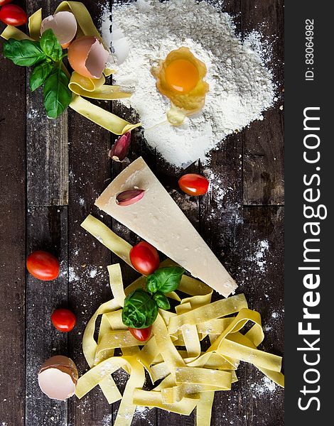 Pasta Tomatoes and Flour With Egg Shells on Table