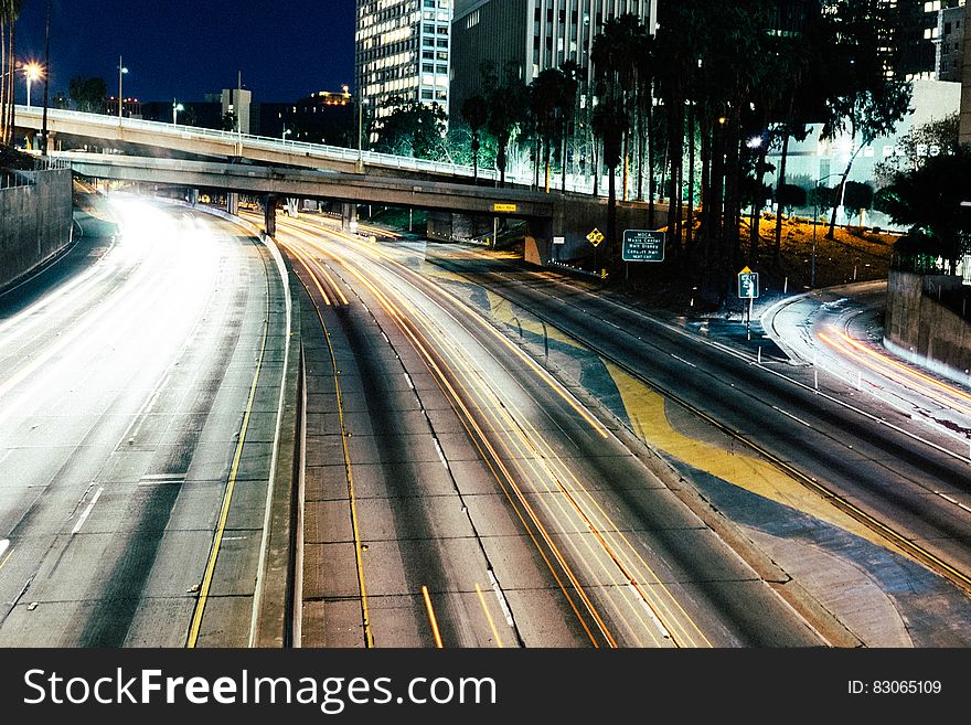 Blur of headlights on city freeway at night.