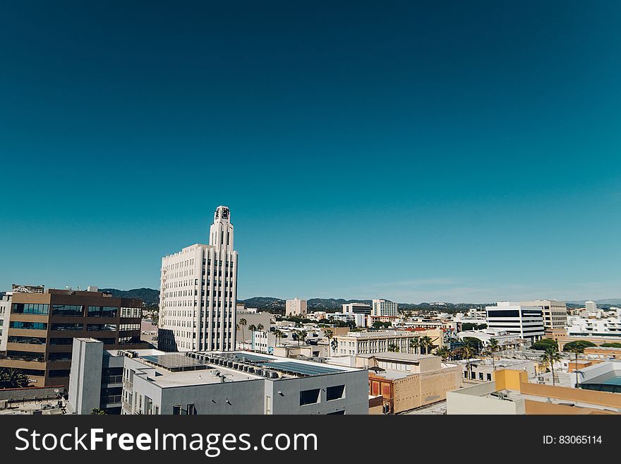 Aerial view over rooftops of Santa Monica, California on sunny day against blue skies.