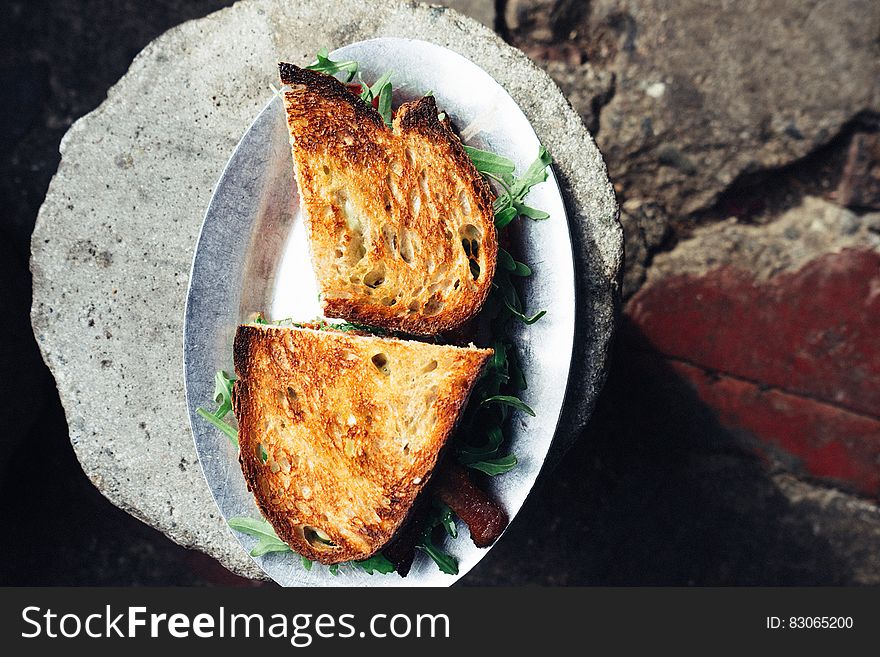 Arugula salad sandwich in toasted bread viewed from above.
