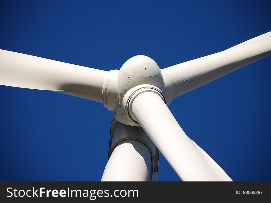 Low Angle Photo of White Wind Turbine Under Deep Blue Sky