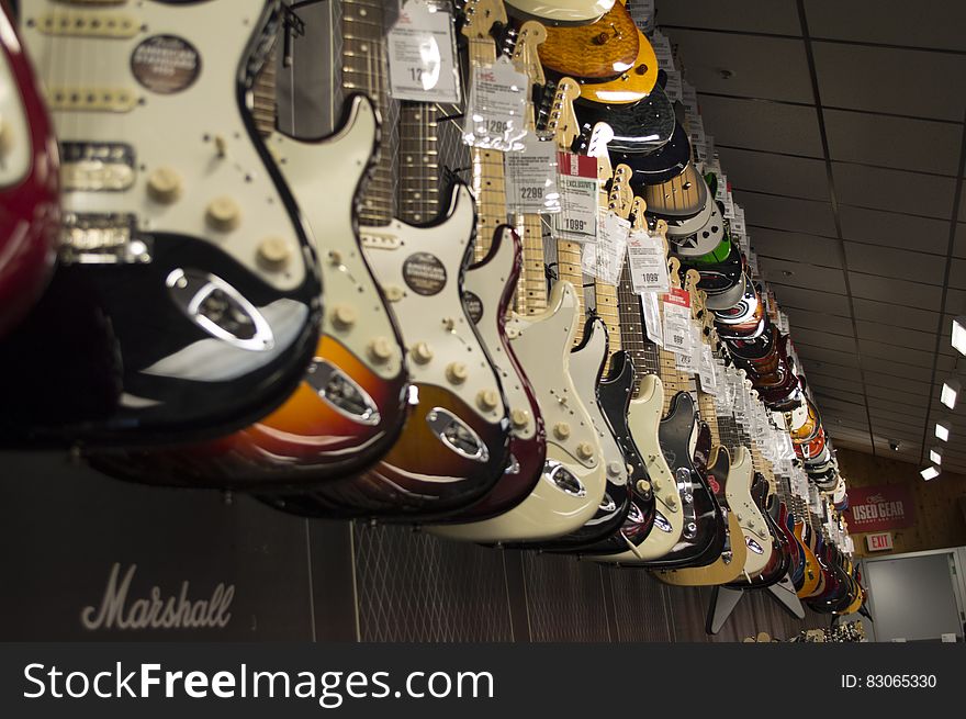 Electric Guitar Hanging Near Wall