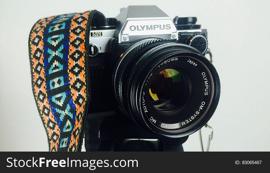 Black and Gray Olympus Dslr Camera White Orange Blue and White Strap