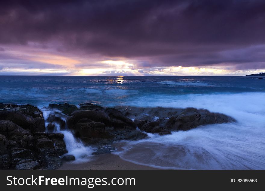 Sea Under Gray Sky During Day Time