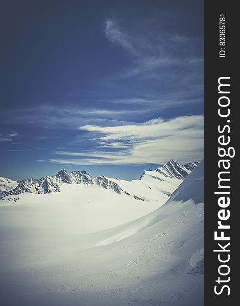 Mountain Surrounded By Snow Under Blue Sky