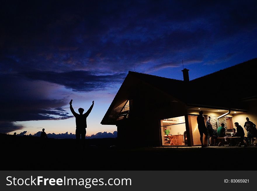 Silhoutte of Person Standing during Night Time