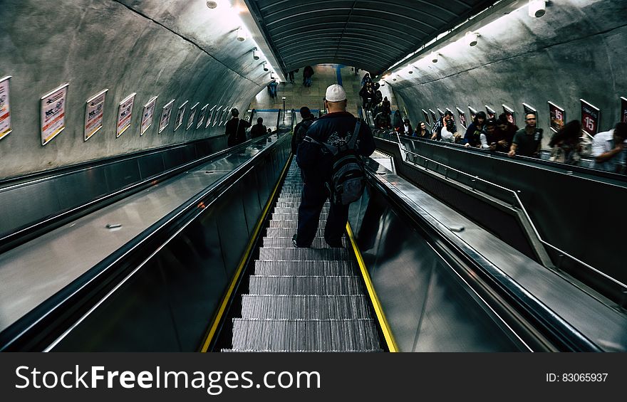 Man in Black Leather Jacket on Escalator