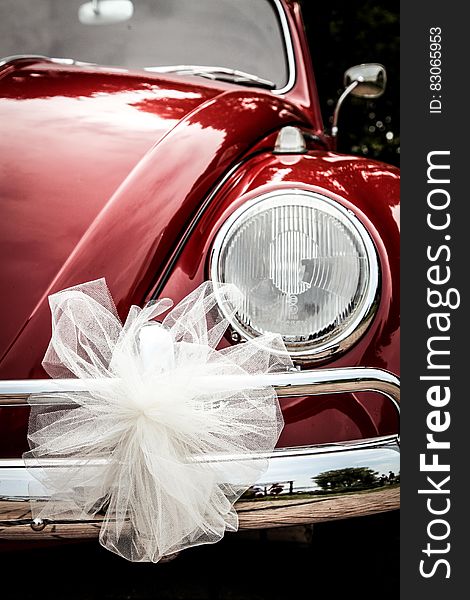 Vintage red VW Beetle with white bow for wedding. Vintage red VW Beetle with white bow for wedding.