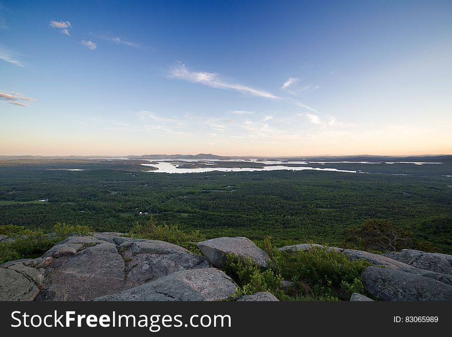 Grey Rocks Cliff Overlooking Marsh during Daytime