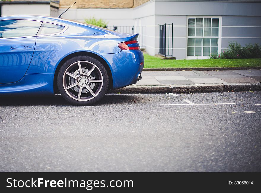 Blue Car Parked Near Grey And White Painted House