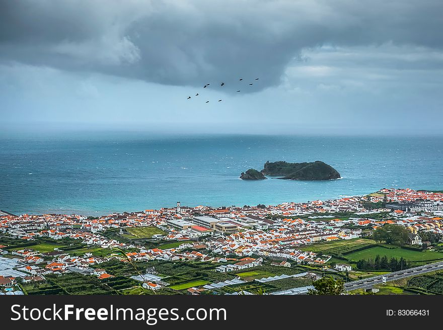 Coastal city on waterfront in Azores, Portugal with overcast skies. Coastal city on waterfront in Azores, Portugal with overcast skies.