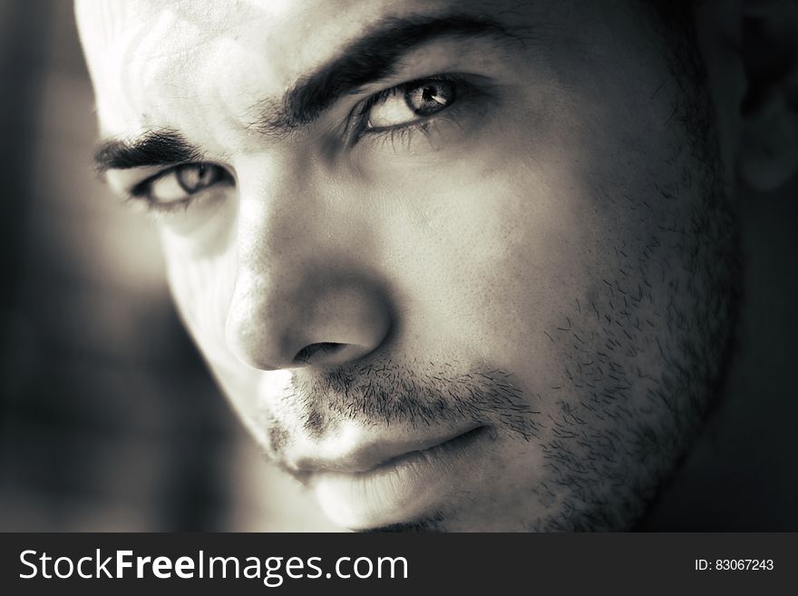 A monochrome close up of an attractive man's face. A monochrome close up of an attractive man's face.
