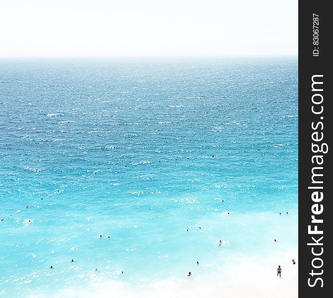 Blue seas and people swimming in the water.