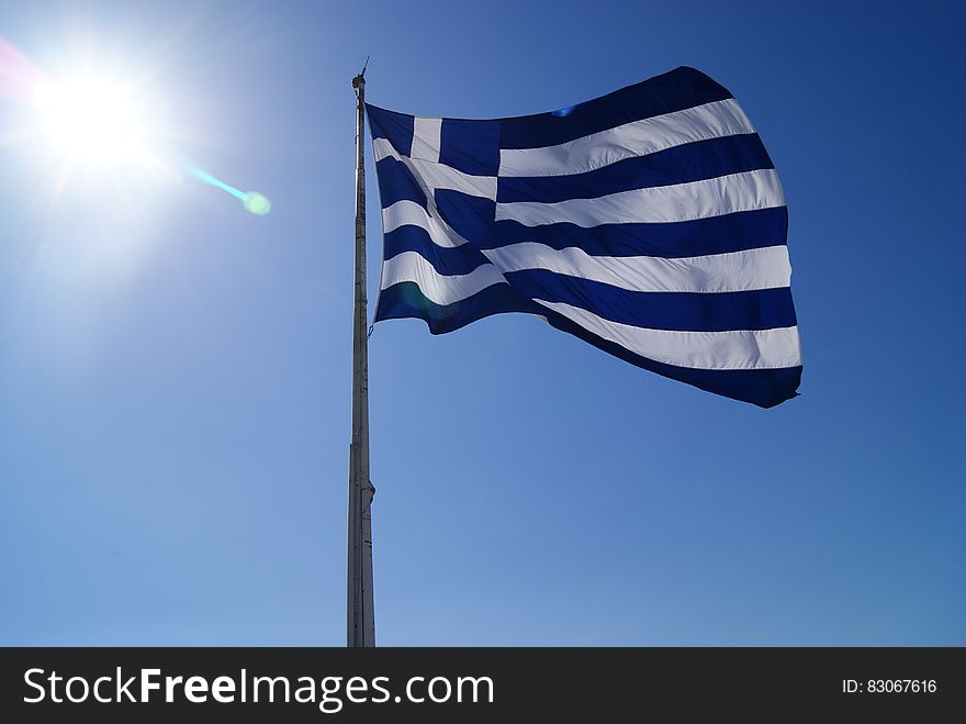 The flag of Greece flying against the blue skies. The flag of Greece flying against the blue skies.