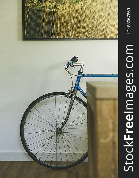 Bicycle Resting Against An Indoor Wall