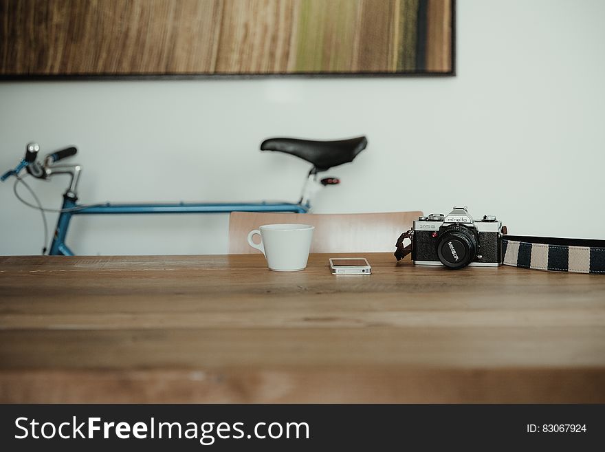 Camera And Smartphone On Desk