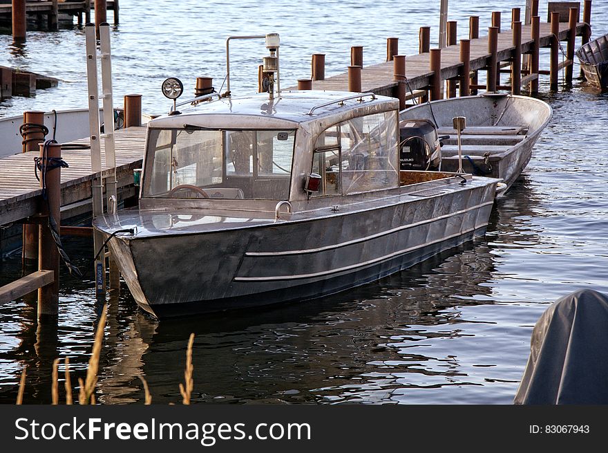 Product Photography of Silver Motor Boat Neck Dock during Daytime