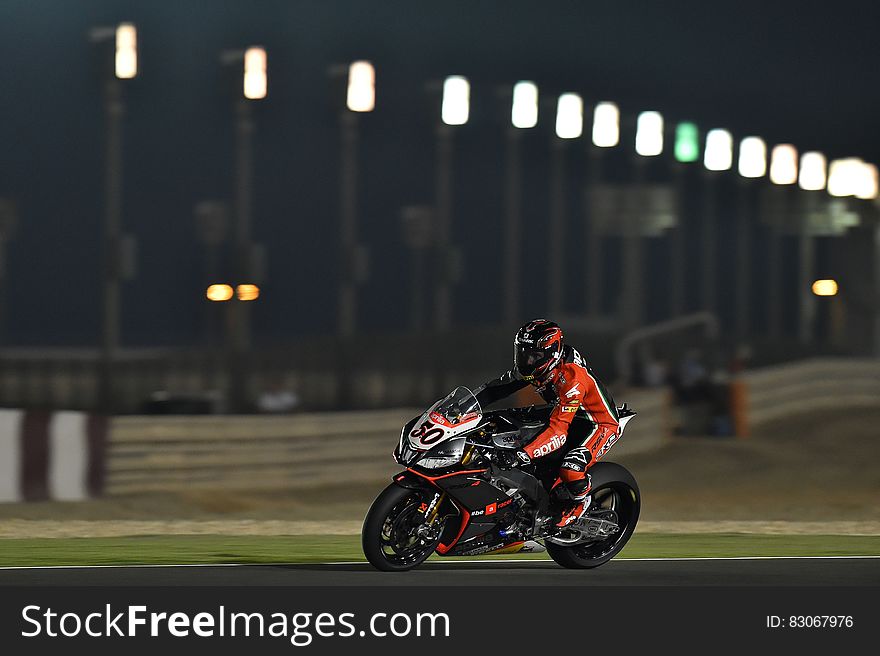 Person Riding Super Bike During Night Race