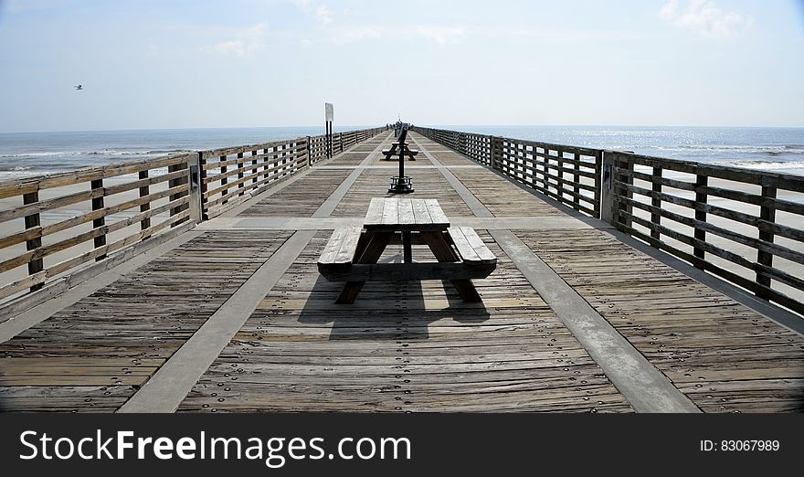 Black Wooden Picnic Table on the Wooden Dock