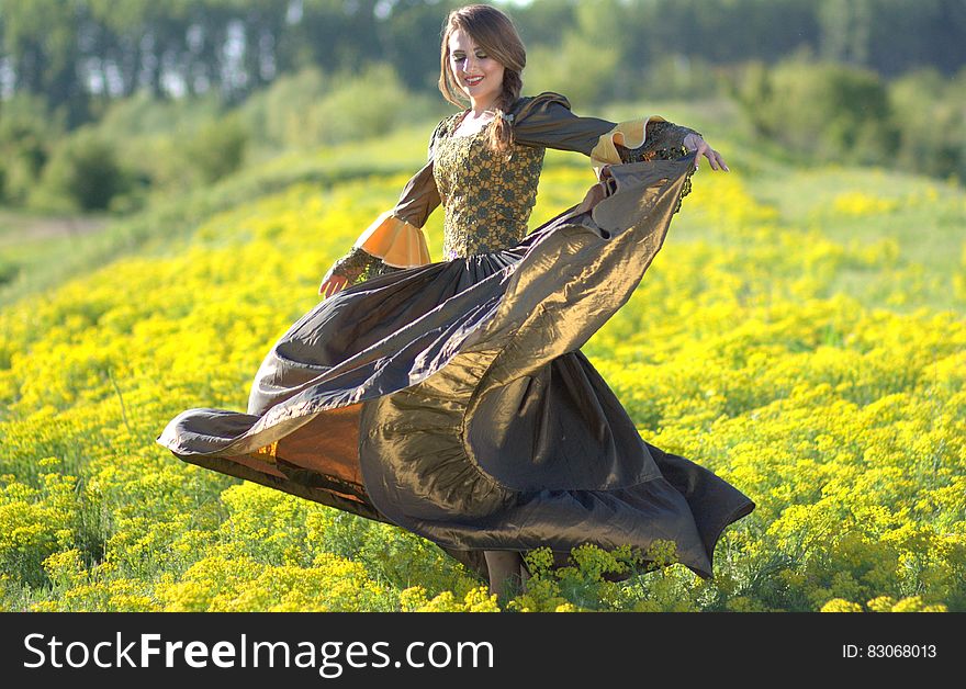 Woman on Princess Costume Waving Her Dress on Green Flower Fields