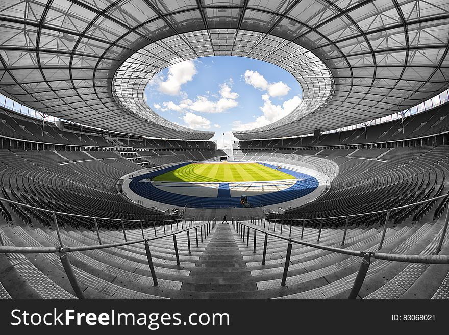 Selective Color Photography Of Person At Soccer Stadium During Daytime