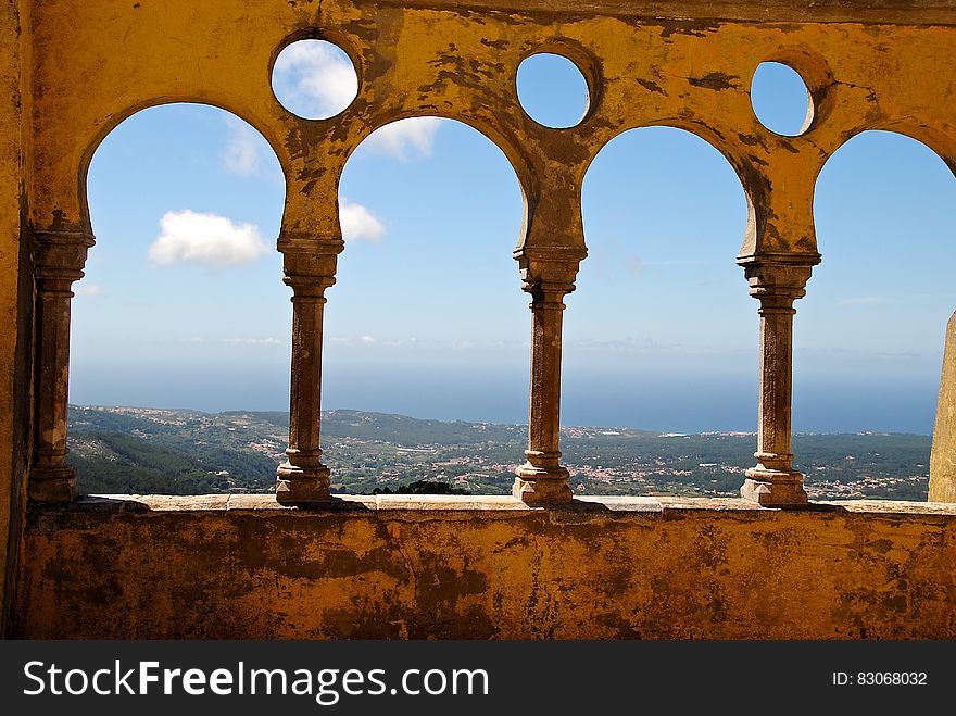 Grey Concrete 3 Baluster Near Mountains And Sea During Daytime