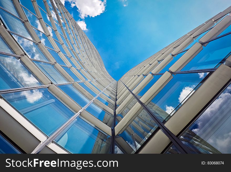 White Building Under Clear Blue Sky in Worms Eye View Photography