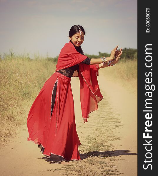 Woman in Red and Black 3/4 Sleeve Dress Dancing