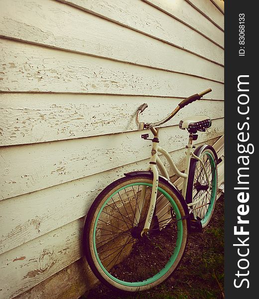 White and Teal Beach Cruiser Bike Beside White Painted Wooden Wall