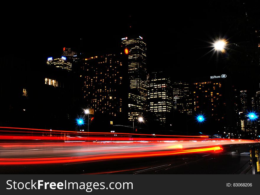 Time Lapse Photography Of Red And Orange Taillight In City During Daytime