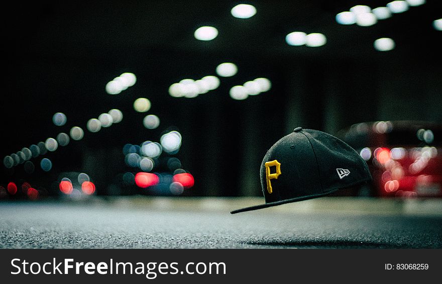 Black and Yellow P Cap Hanging in the Air